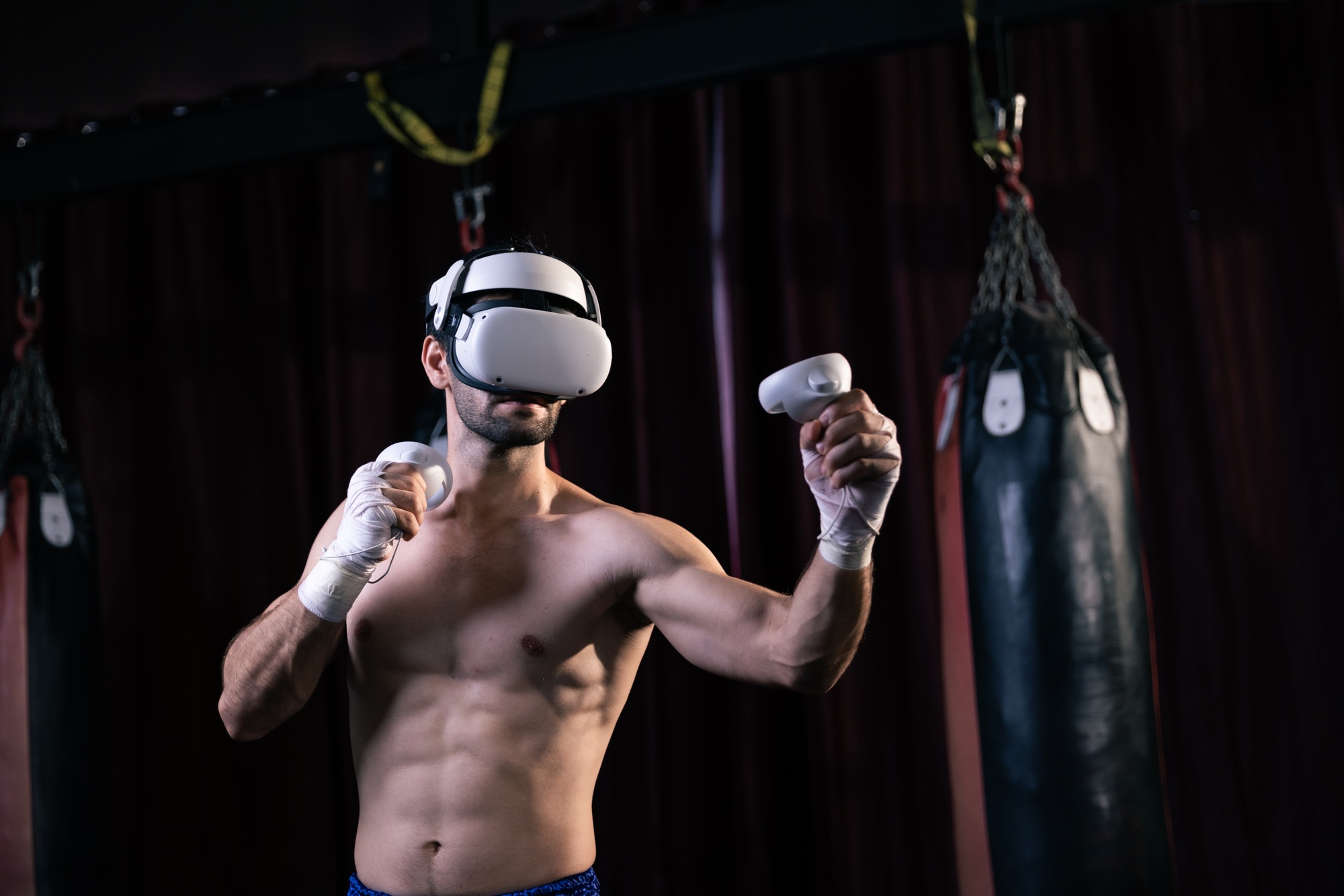 Young man using VR boxing at the Gym.With VR boxing, users can experience a variety of scenarios
